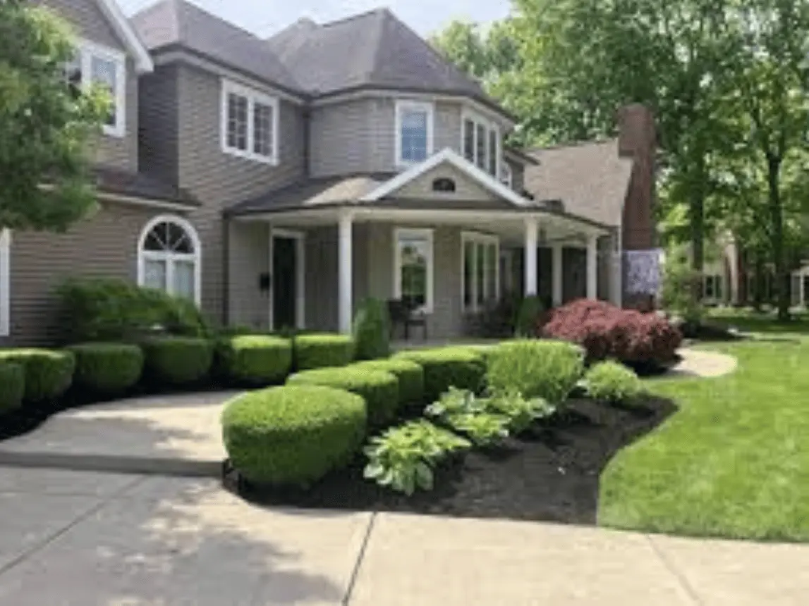 a house in lubbock city with a well done lawn and landscapes in it's backyard