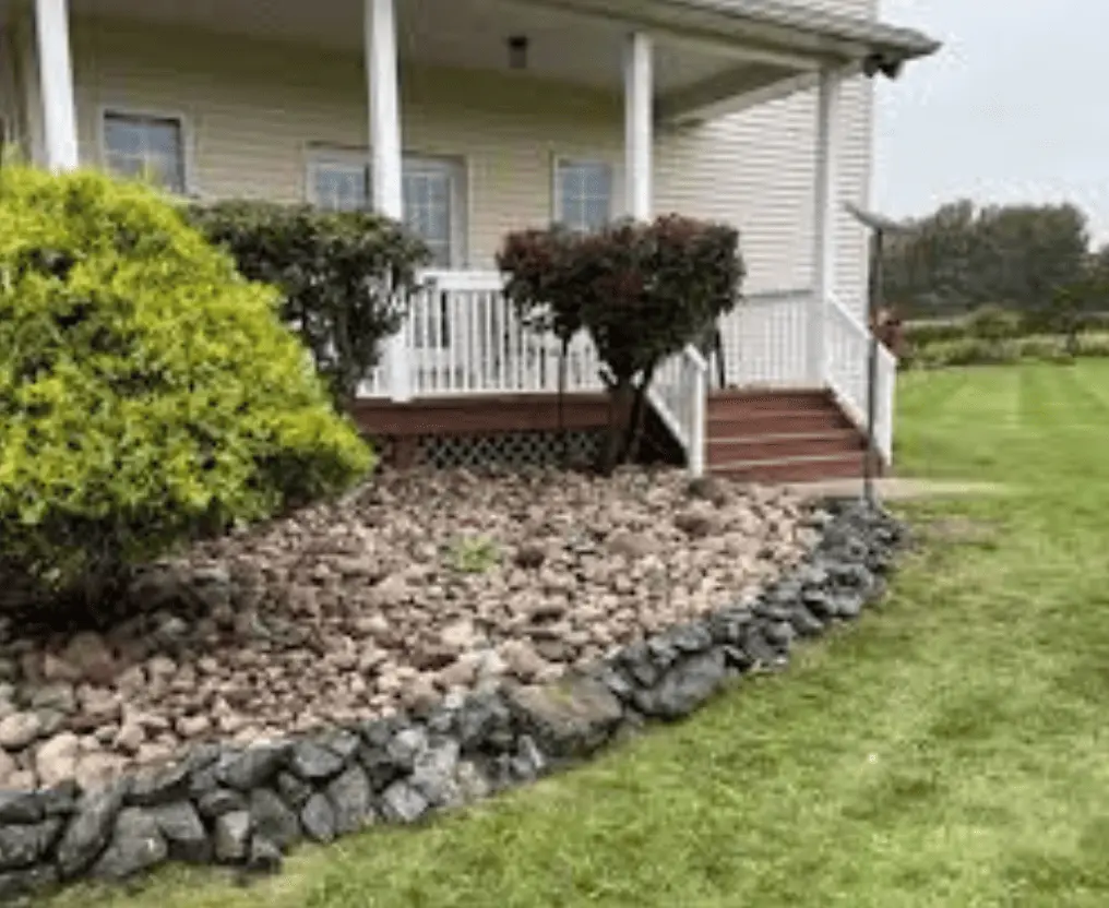 a residential property with a beautifully maintained lawn and landscapes in backyard