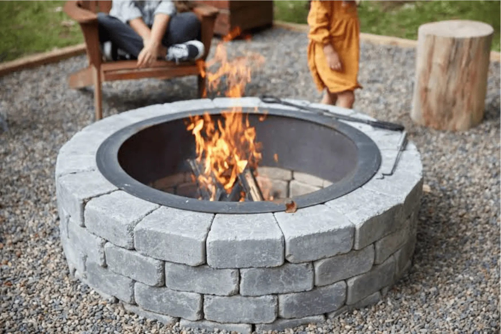 Custom outdoor fire pit with seating area built in a Lubbock backyard